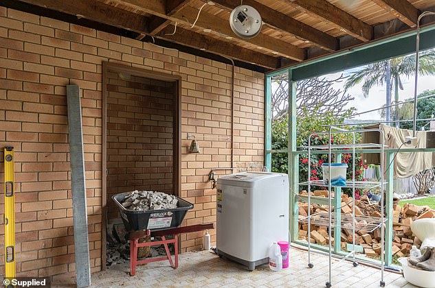 The dull-looking laundry originally had exposed yellow brick and sat at the front of the couple