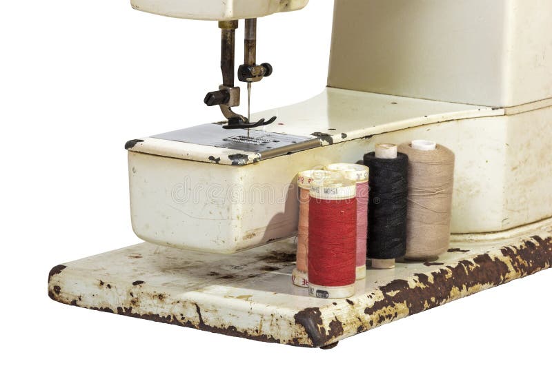 Close Up of Arm of Old Sewing Machine with Cottons. Close up side view of arm of rusted old sewing machine with different color grungy cotton reels on white stock photos