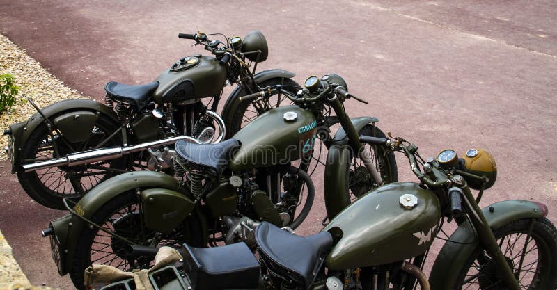 Normandy, France; 4 June 2014: Vintage U.S. army WWII motorcycles on display. Metal willys war transport camp armored old us off-road historic caliber stock photography