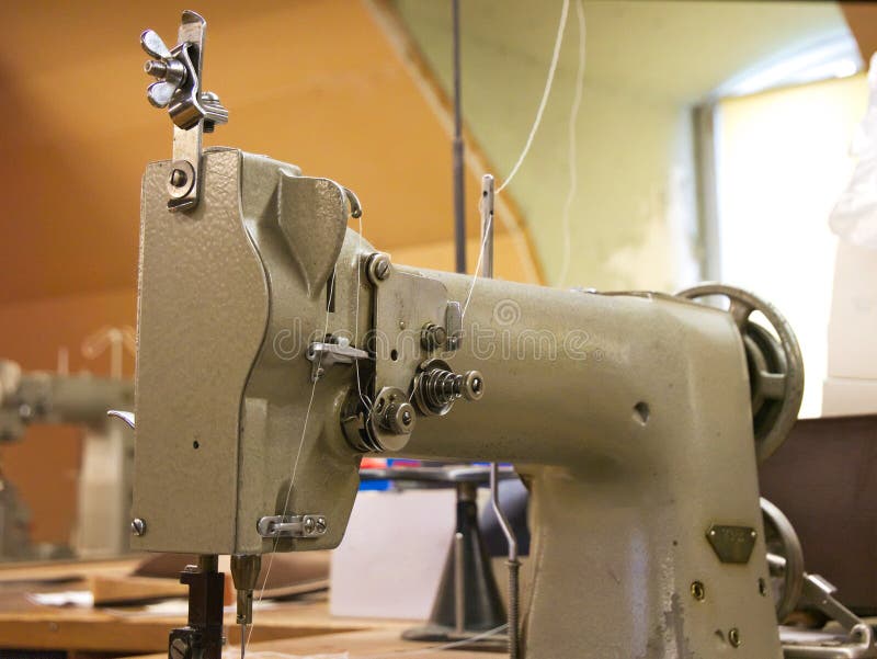 Old industrial factory sewing machine in close up royalty free stock photography