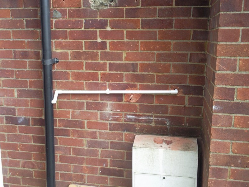 A condense pipe connected to a downpipe.